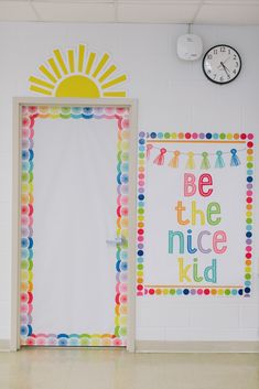 there are two doors with the words be the nice kid painted on them and a clock