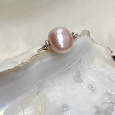 A pink pearl pinky ring on a simple silver band. * 9mm x 8mm natural pale pink freshwater pearl  * natural baroque pearl * Argentium silver band - better than sterling. See below. * U.K. size H / US size 4 (not your size? Message me) * minimalist design  This pearl has the palest pink nacre with a unique, baroque surface. The pearl will turn on the bar to reveal the banded surface of its other side.  Fitting comfortably flat on the finger on a slim, argentium silver band, this silver pearl ring Delicate Pearl Drop Ring As Gift, Delicate Pink Stackable Rings For Gifts, Elegant Pink Sterling Silver Stackable Rings, Adjustable Pearl Charm Ring For Wedding, Adjustable Oval Pearl Ring For Wedding, Oval Rings With Pearl Drop For Gifting, Adjustable Pearl Stackable Wedding Rings, Adjustable Wedding Ring With Pearl Charm, Oval Pearl Drop Ring For Gift