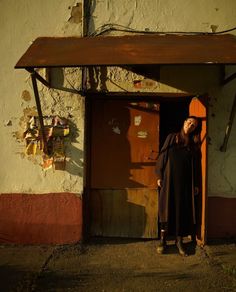 a woman standing in front of a doorway