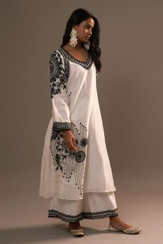 White kurta with floral, beads hand embroidery. Paired with palazzo.
Components: 2
Pattern: Embroidered
Type Of Work: Floral
Neckline: V neck
Sleeve Type: Oversized
Fabric: Summer Silk
Color: Black
Other Details: 
Cutwork border
Attached lining
Length:
Kurta: 46 inches
Palazzo: 38 inches
Occasion: White - Aza Fashions Designer Semi-stitched Kaftan With Mirror Work, Wedding Chanderi Kaftan With Mirror Work, Eid V-neck Kurta With Intricate Embroidery, Traditional Designer Kaftan With Mirror Work, Unstitched Kaftan With Mirror Work For Wedding, Bohemian Chanderi Palazzo Set With Chikankari Embroidery, Traditional Embroidered Dress With Mirror Work For Designer Wear, Multicolor Embroidered Palazzo Set For Eid, Traditional Embroidered V-neck Palazzo Set