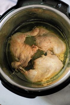 two chickens are cooking in an electric pressure cooker