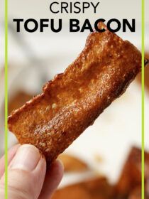 crispy tofu bacon is being held up in front of the camera