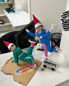 two elf dolls sitting on top of a table