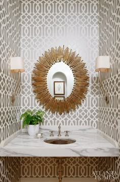 a bathroom vanity with a mirror, sink and two lights on the wall above it