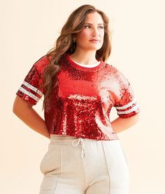 DH Apparel Varsity Sequin Cropped Top - Red Small, Women's Crimsonred All-over sequin knit lined top Striped sleeve hits Bust measures 41 on size small Body length 18 3/4 on size small. 100% Polyester. Spot clean only. Do not bleach. Flat dry. Low iron on reverse. Do not dry clean. Apparel & Accessories > Clothing > Shirts & Tops Fall Crew Neck Top With Contrast Sequin, Glamorous Fall Top With Contrast Sequin, Glamorous Contrast Sequin Top For Fall, Fall Contrast Sequin Crew Neck Top, Glamorous Fall Tops With Contrast Sequin, Party Crew Neck Top With Contrast Sequin, Contrast Sequin Crew Neck Top For Party, Glamorous Short Sleeve Tops For Fall, Short Sleeve Top With Sequins For Fall