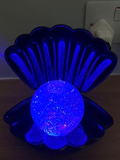 a blue glass bowl sitting on top of a wooden table