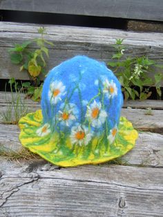 Beautiful hat with meadow of daisies on it. Unique hat in which you will feel amazingly good. Hat has a wide usage: it can be a sauna hat or a hat for a special occasion or teapot warmer. As a sauna hat it will protect your head and hair from the heat, as teapot cover it will keep the teapot warm. This hat is made of 100% wool using wet felting technique. Materials: New Zealand sheep wool 100% This hat is not on stock. This hat is made to order. Final product will be a little different than this Spring Brimmed Felt Hat, Spring Felt Brimmed Hats, Spring Curved Brim Felt Hat, Handmade Spring Cloche Hat, Handmade Brimmed Felt Hat For Spring, Fairy Hat, Sauna Hat, Teapot Warmer, Teapot Cover