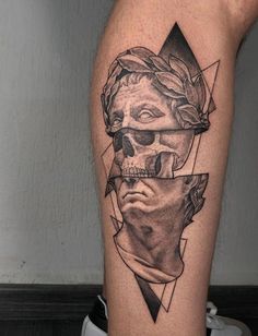 a man's leg with a black and white tattoo on it, depicting the face of abraham lincoln