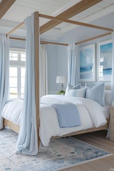 a bedroom with four poster bed, blue curtains and white linens on the walls