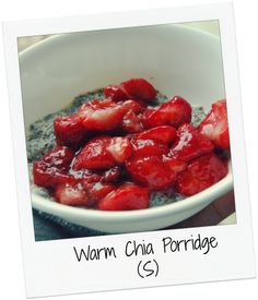 a bowl of oatmeal with strawberries in it and the words warm chia porridge