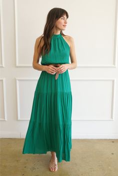 Feel the wind in your hair and the sand between your toes. This luxurious, beautiful emerald maxi dress is perfect for any occasion. Made from a high-quality, silky soft fabric and elastic at the waist, not only will you be looking elegant and chic, but you won’t have to give up comfort with our Gia dress. You'll be sure to turn heads whenever you're wearing it! Responsibly handmade in Bali with all the love.How it Fits Fits true to size Model Measurements: Height:5'9", Waist: 24.5", Bust:33 B, Gia Dress, Skirt Fabric, Carbon Offset, Halter Neckline, Sustainable Fabrics, Tiered Skirt, The Sand, Model Measurements, The Wind