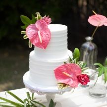 a white cake with pink flowers on top