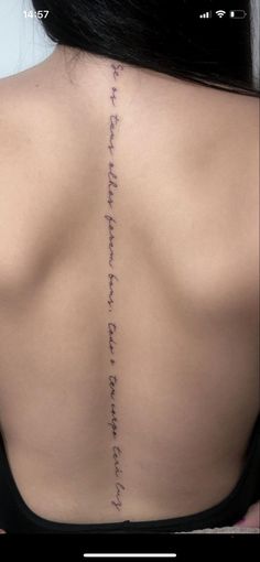 the back of a woman's neck with writing on it