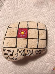 a rock that has some writing on it