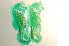 there are two green seahorses on top of each other