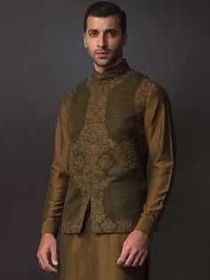 WaistcoatColor: Olive DrabFabric: Raw SilkSmart looking designer waistcoat features delicate embroidery accent the front and collarHidden front hooks closureInner:Complement with dark brown kurta and pajama.Additional Accessories:Peshawari Sandal / Khussa: US$30 Traditional Sets With Stand Collar For Fall, Traditional Fall Sets With Stand Collar, Traditional Stand Collar Kurta For Fall, Festive Kurta With Stand Collar For Fall, Traditional Fitted Nehru Jacket For Fall, Festive Fall Kurta With Stand Collar, Fitted Nehru Jacket With Zari Work For Fall, Embroidered Nehru Jacket For Eid And Semi-formal Occasions, Embroidered Nehru Jacket For Semi-formal Eid Occasions