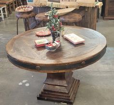 a wooden table with some books on it and a christmas tree in the centerpiece