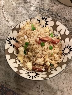 a bowl filled with rice and peas on top of a table