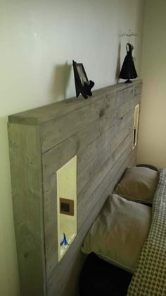 a wooden headboard made out of wood with two black cats on top of it