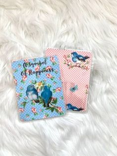 two small notebooks with blue birds on them