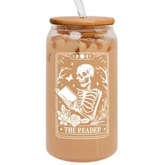 a jar filled with beans next to a straw in the bottom and a wooden lid