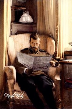 a man sitting in a chair reading a newspaper