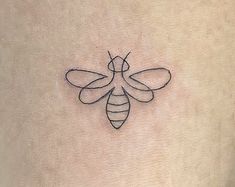 a bee tattoo on the back of a woman's stomach