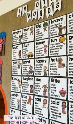 a bulletin board with words and pictures on it in front of a classroom wall that says in other words