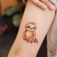 a small slotty tattoo on the right arm and leg, with an adorable face