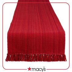 a red table runner with fringes on it