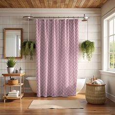 a bathroom with a pink shower curtain next to a tub