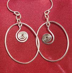 Love this sterling silver (.925) wire shape with a dangle swirl of wire.  Drop is approx 1.0 inch and so light you will forget they are swinging from your ears!!  Handmade by Ray, all Sterling to include ear wires.   #10075 Nickel-free Spiral Hoop Earrings Elegant Style, Elegant Spiral Wire Wrapped Hoop Earrings, Elegant Swirl Hoop Earrings As Gift, Spiral Shaped Sterling Silver Jewelry, Spiral Sterling Silver Jewelry For Anniversary, Nickel-free Round Silver Plated Wire Jewelry, Silver Hypoallergenic Wrap Earrings For Gift, Hypoallergenic Round Silver-plated Earrings, Hypoallergenic Round Silver Plated Earrings