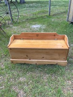 a wooden box sitting in the grass