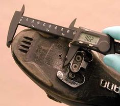 a close up of a person holding a caliper