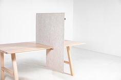 a table and chair made out of plywood with an open door at the end