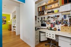 a home office with white desks and wooden floors