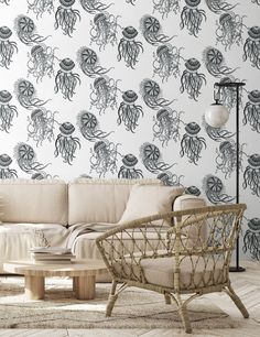 a living room with an octopus wallpaper and wicker chair in front of the couch