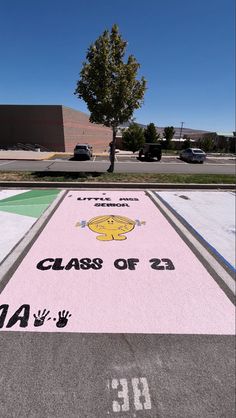 a parking lot that has a painted sign on the ground with words class of 2012