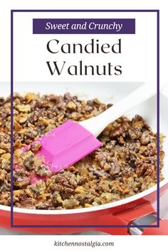 a pink spatula in a red pan filled with candied walnuts and crumbled