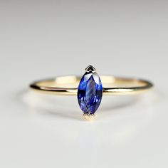 This beautiful natural blue sapphire is marquise shape and featuring in a 14k yellow gold prong setting and 14k yellow gold band. Minimalist, dainty jewelry. DETAILS ABOUT THE RING, MATERIAL AND STONES***Sapphire is marquise cut , 6x3mm.***14k solid yellow gold band is 1 mm thick. This ring was hand made in our small studio in California.Sapphires are believed to symbolize wisdom, virtue, good fortune, and holiness for royals. In an engagement ring, a sapphire means faithfulness and sincerity, t Jewelry Details, Blue Sapphire Ring, Topaz Jewelry, Tourmaline Jewelry, 5th Anniversary, Aquamarine Jewelry, Garnet Jewelry, Small Studio, Moonstone Jewelry