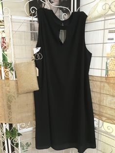 Introducing our Black Sleeveless Dress Plus, a sophisticated twist on the classic black dress. With a high keyhole neck in both the front and back, this dress exudes elegance. Its sleeveless design and flowy silhouette create a wonderful sense of movement. Made of 95% polyester and 5% spandex, our dress is both comfortable and stylish for our plus size customers. Elevate your wardrobe with this luxury piece. Sleeveless Mini Dress With Keyhole Back, Elegant Midi Dress With Keyhole Back For Night Out, Sleeveless Mini Dress With Keyhole Back For Evening, Elegant Solid Color Sleeveless Dress For Night Out, Elegant Solid Sleeveless Dress For Night Out, Elegant Sleeveless Solid Color Dress For Night Out, Sleeveless Midi Dress With Keyhole Back, Classic Black Dress, Keyhole Dress