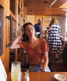 a woman sitting at a table in a restaurant