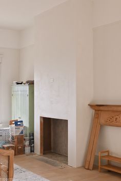 a living room with a fire place next to a window