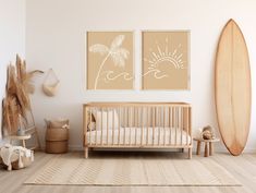 a baby's room with two paintings on the wall and a crib next to it