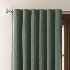 a green curtain hanging on the side of a door