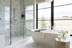 a white bath tub sitting next to a large window