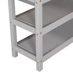 a white wooden shelf with three shelves on each side and one shelf below the shelf