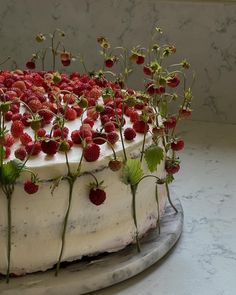 a cake with white frosting and strawberries on top