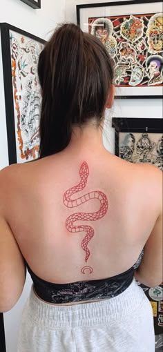 a woman with a snake tattoo on her back