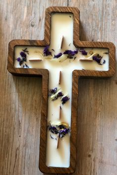 a cross made out of wood with flowers on it